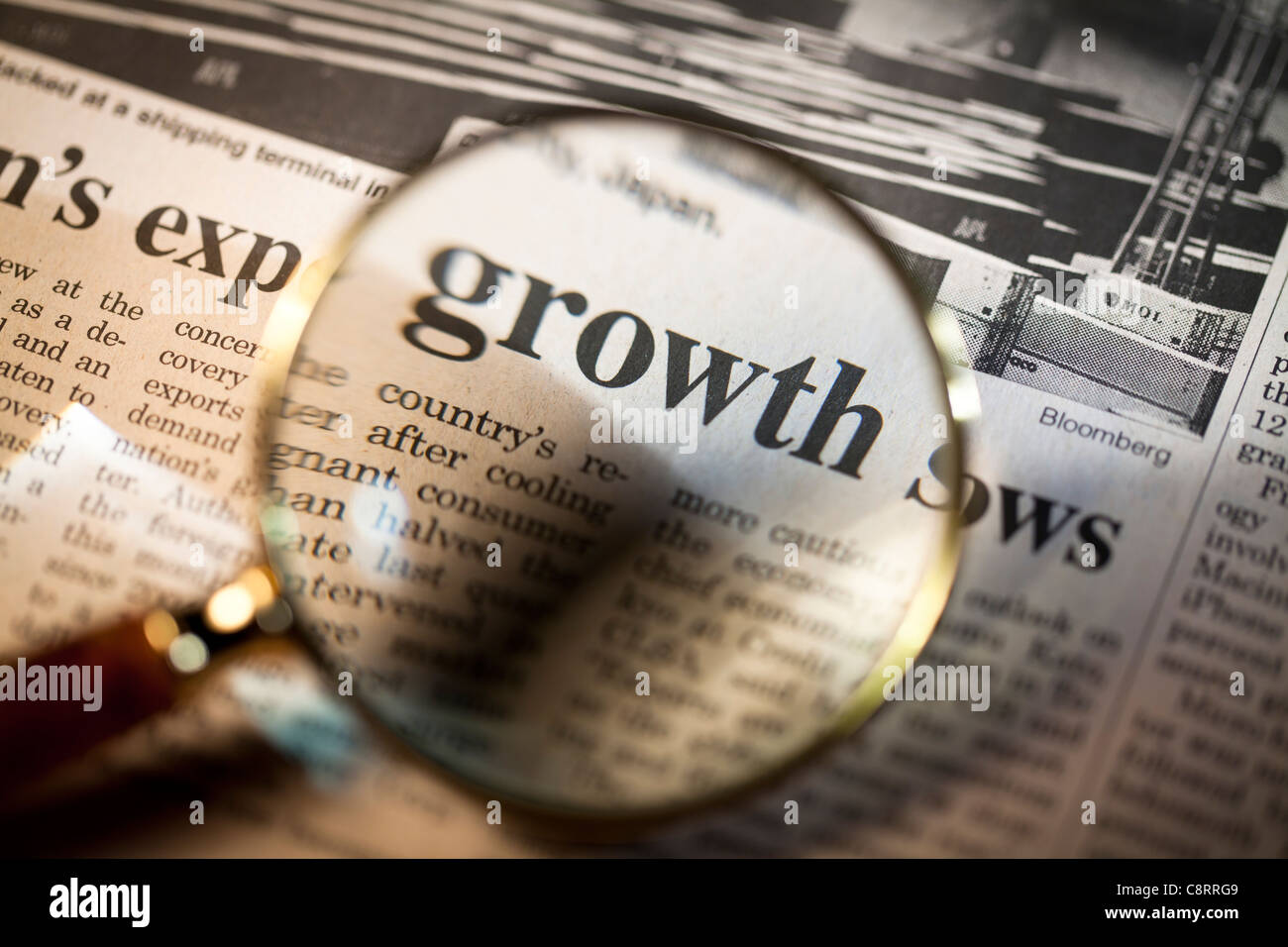 Reading newspaper through magnifying glass Stock Photo Alamy