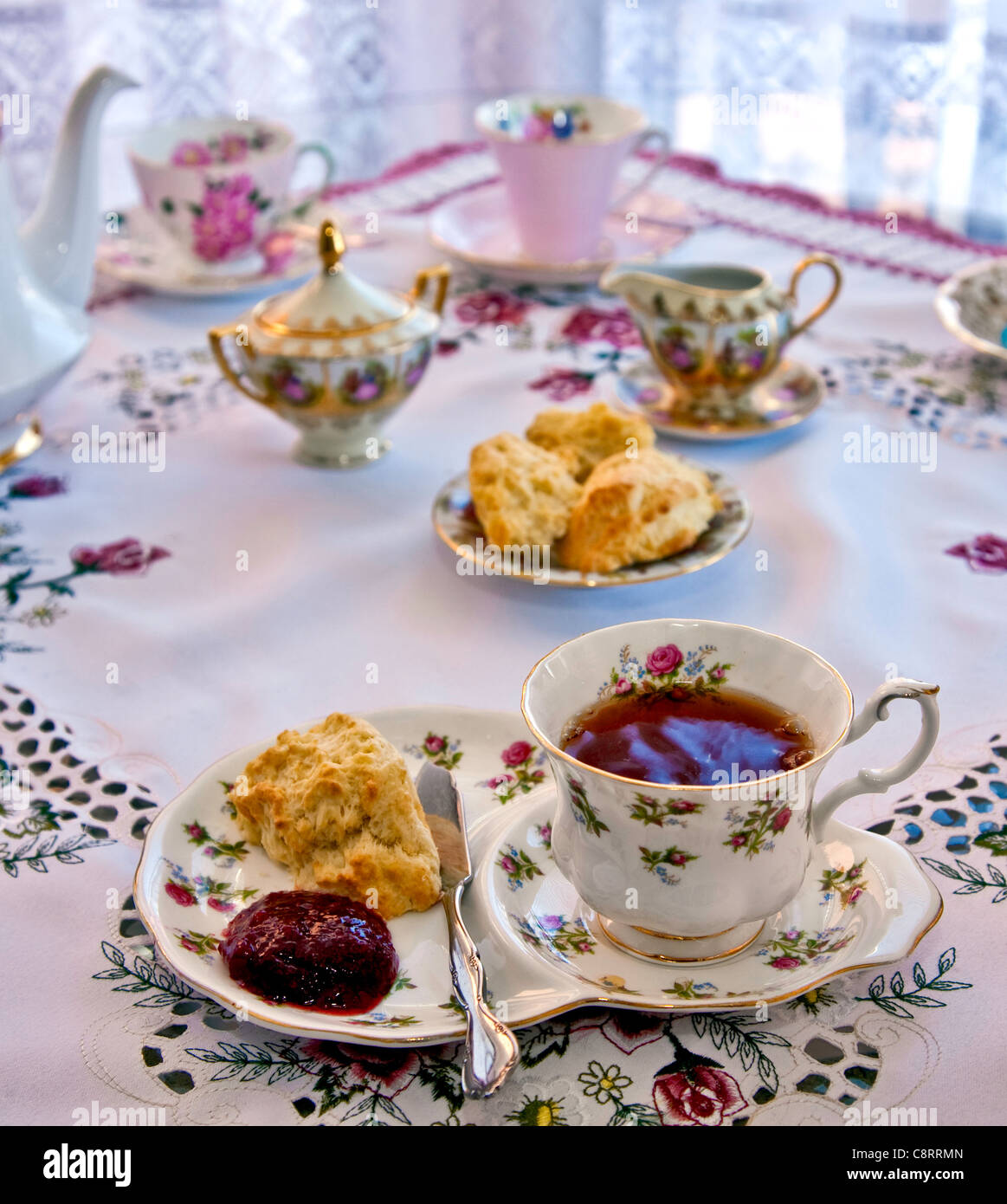English High Tea with scones and Jam at a table setting Stock Photo