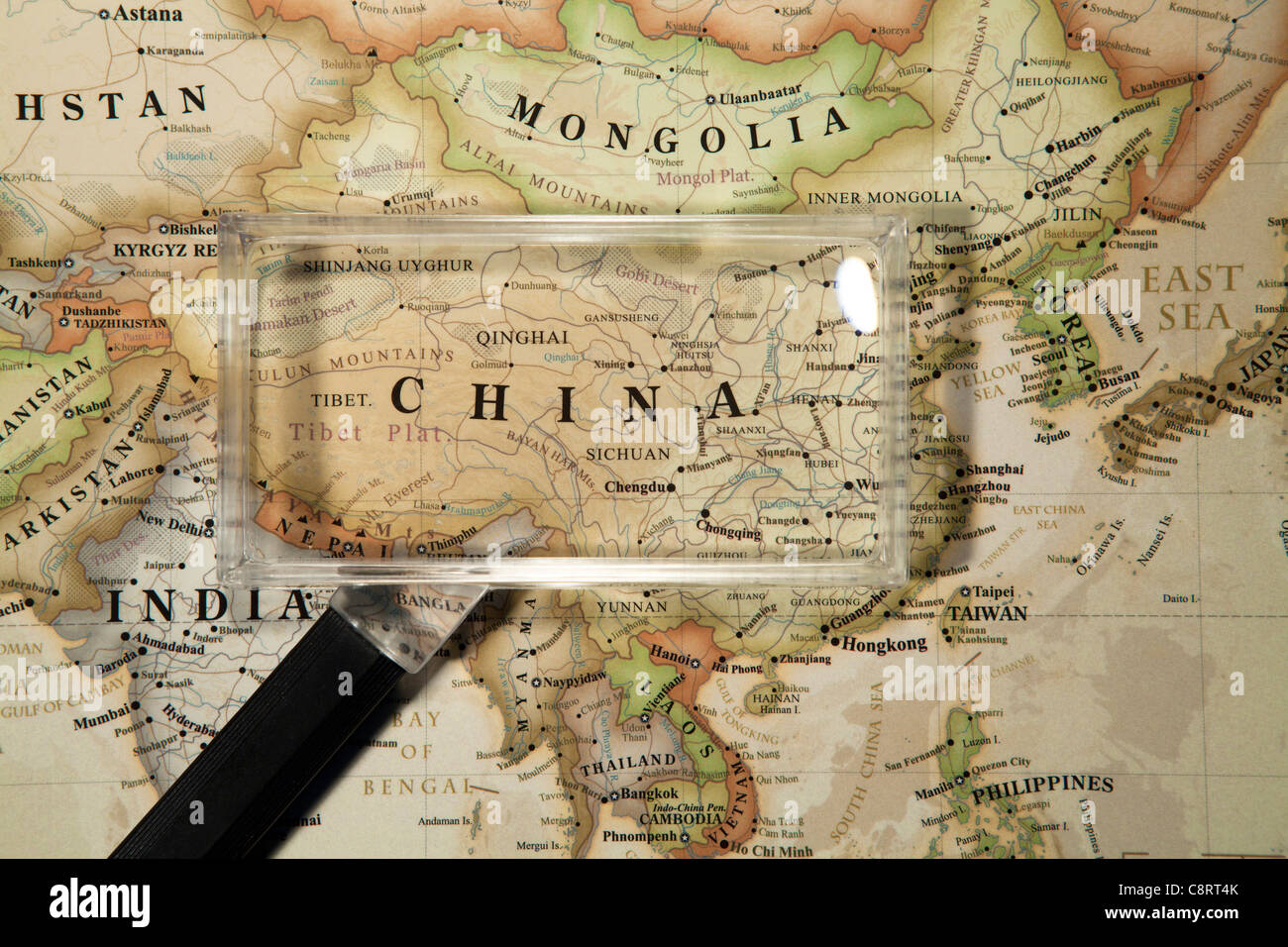 Close-up of Asian continent world map with magnifying glass Stock Photo