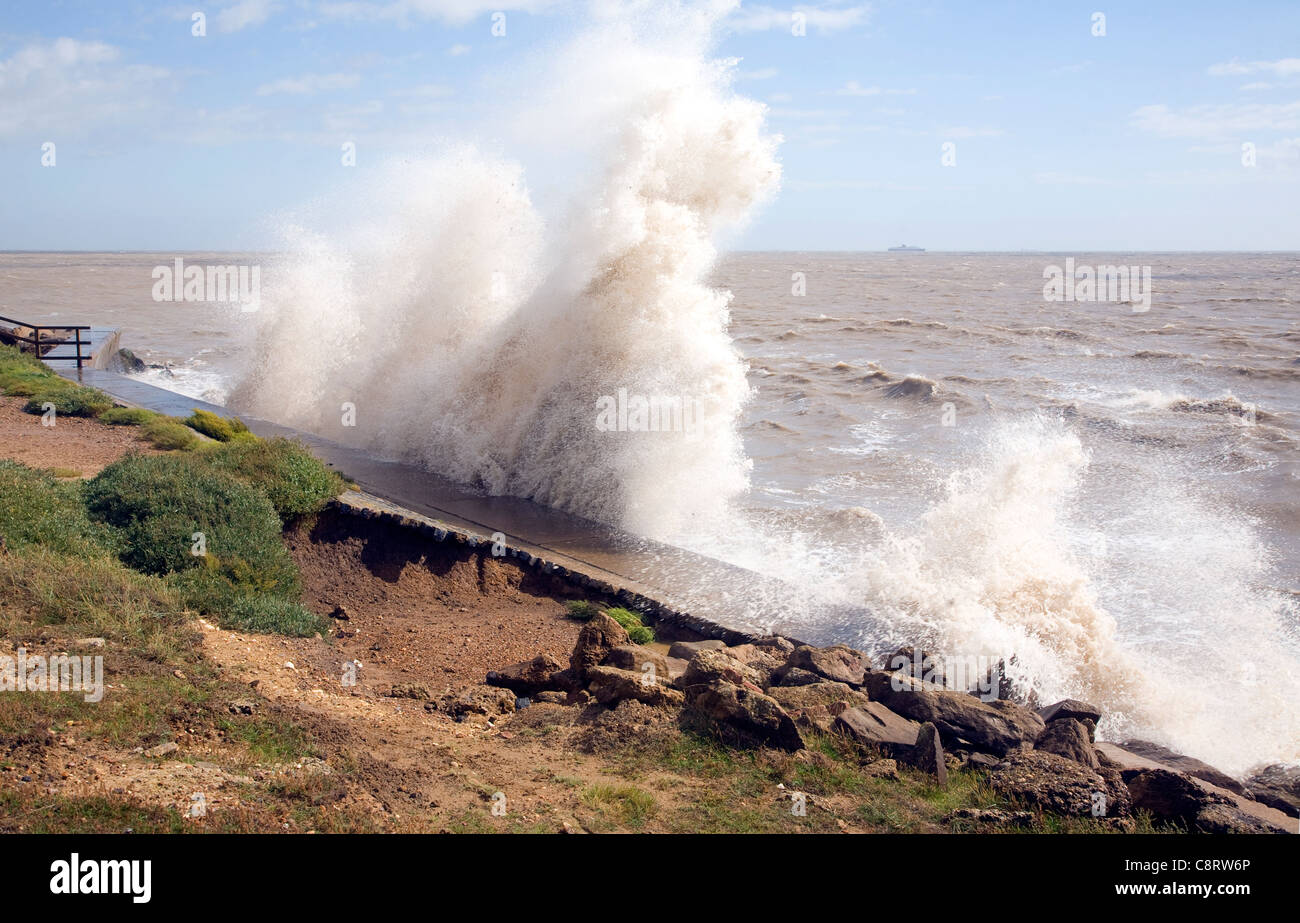 High energy waves eroding sea-wall, Bawdsey, Suffolk, England Stock Photo