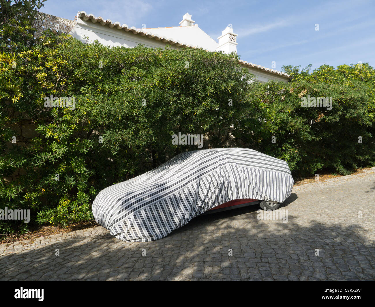 Car under cover protected from sun Stock Photo Alamy