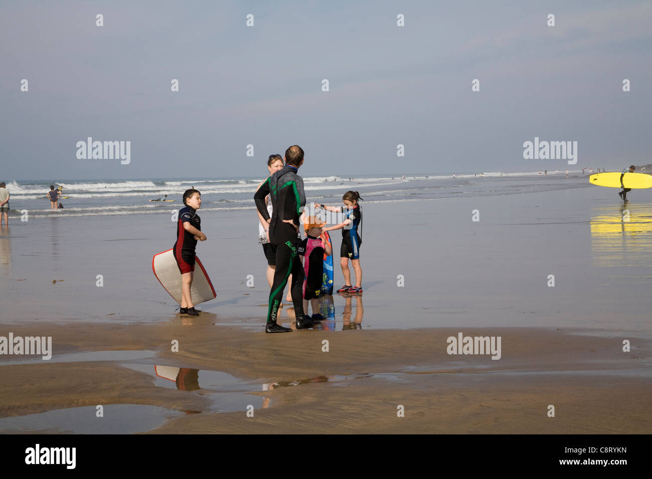 Bude Cornwall England September Man in wetsuit talking to woman with