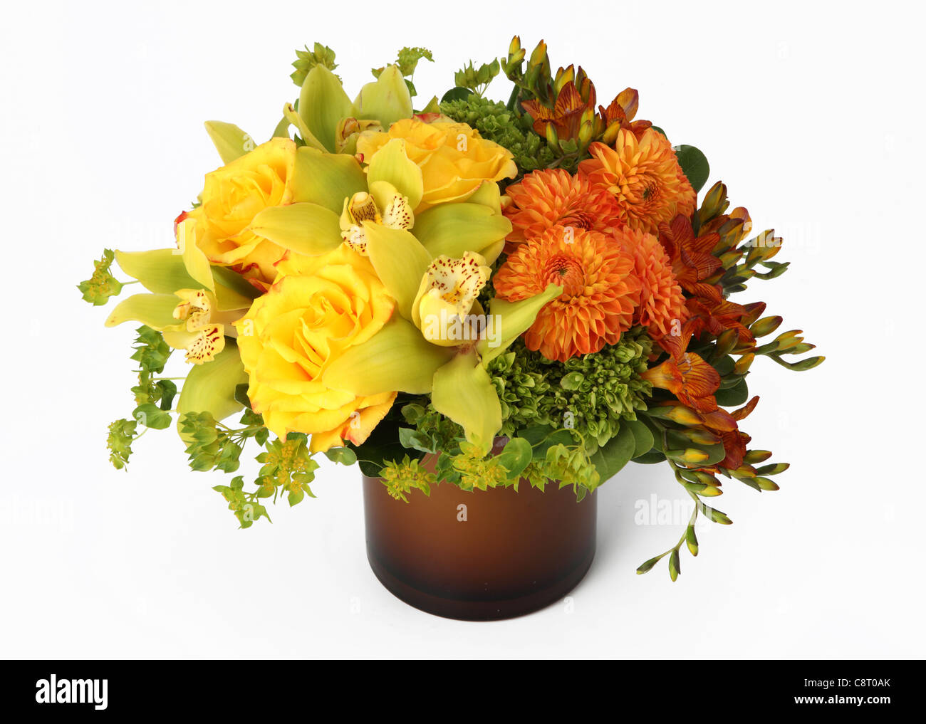 A colorful bouquet of flowers in a vase. Yellow roses, orange dahlias, yellow cymbidium orchids, orange freesias, hydrangea Stock Photo