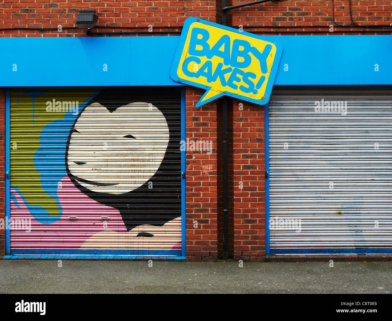 Baby cakes ad on shutter in Northern Quarter Manchester UK Stock Photo