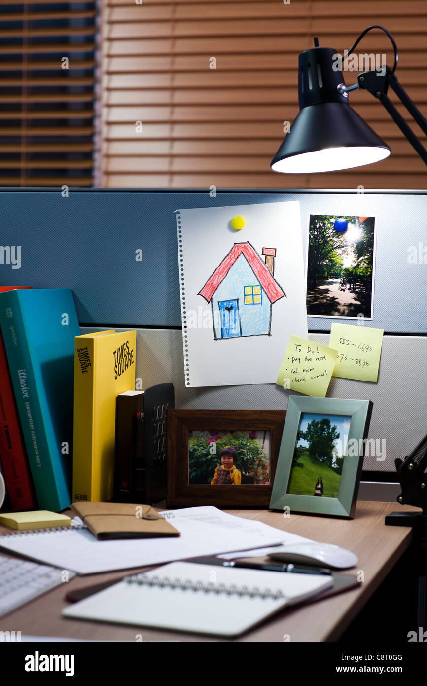 Lamp with painting of house and office stationery on desk Stock Photo