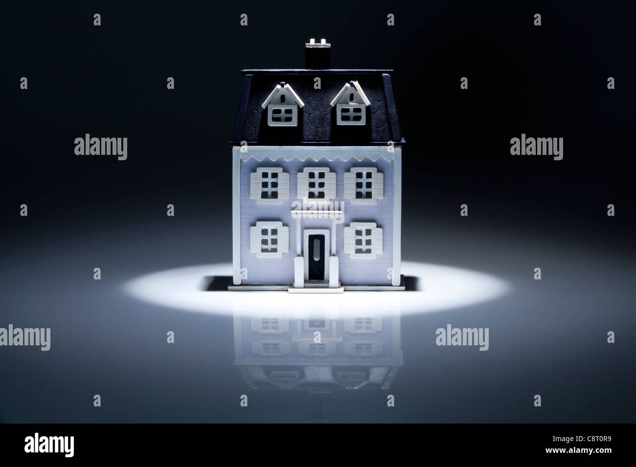 Model of house with spot light on it Stock Photo