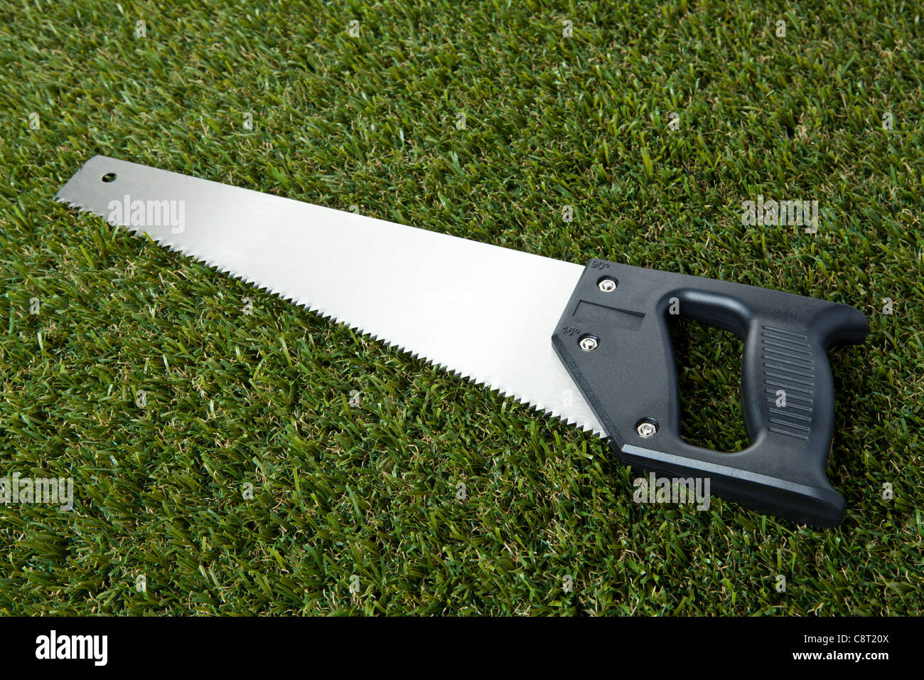 High angle view of handsaw on grass Stock Photo