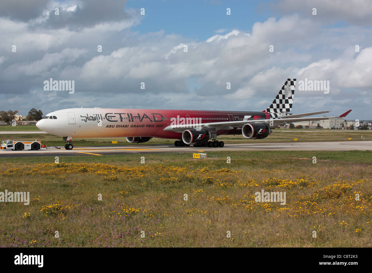Etihad Airways Airbus A340-600 in special Formula 1 livery under tow for maintenance at Malta International Airport Stock Photo