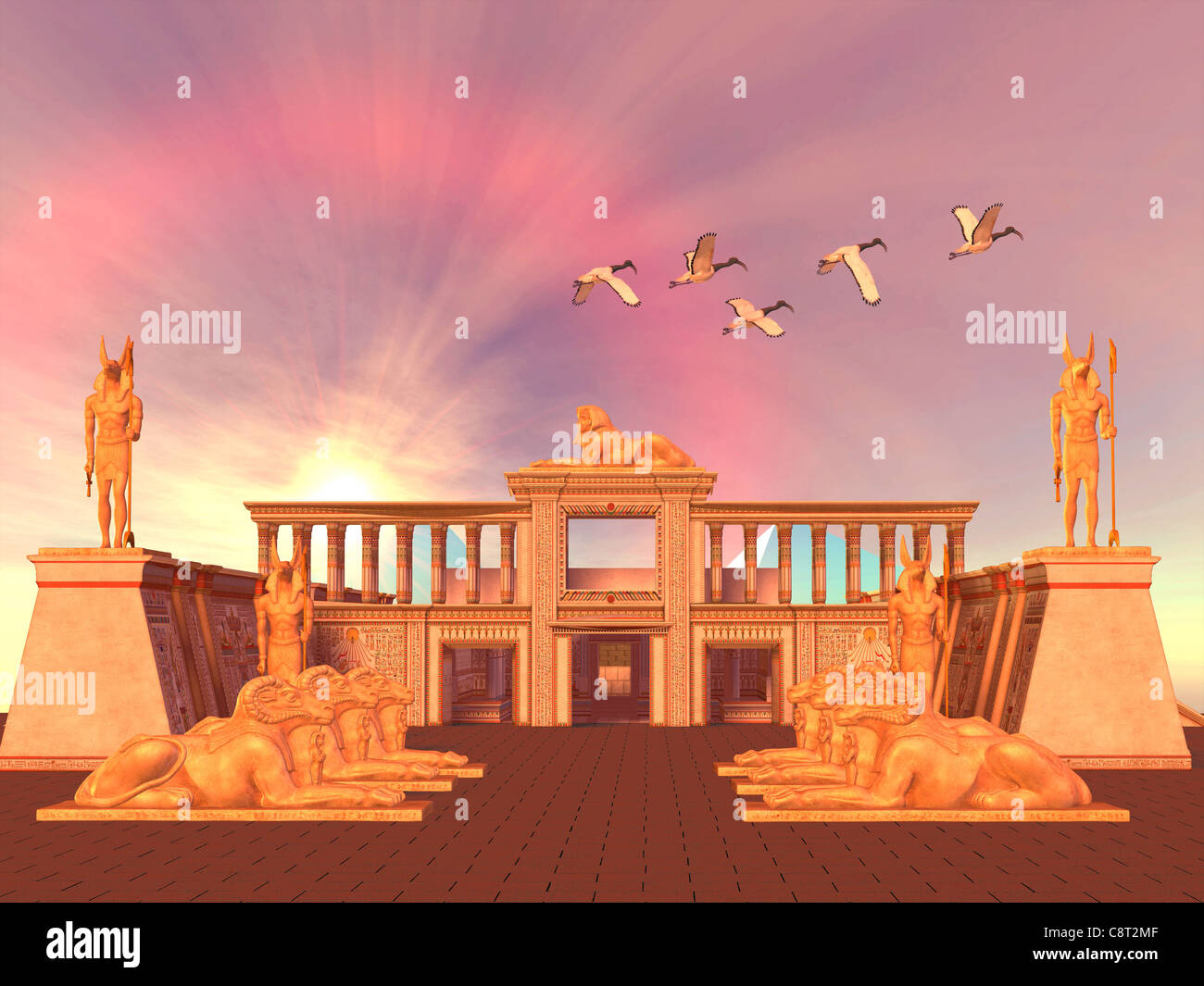 A flock of Sacred Ibis birds fly over an Egyptian palace and its entrance lined with Ram God Khnum statues. Stock Photo