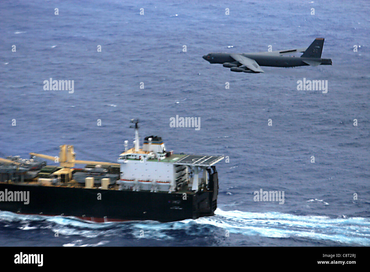 A 2nd Bomb Wing B-52H Stratofortress flies over the UNSN 2nd Lt John P Bobo, a maritime pre-positioning ship, during a maritime intercept training mission, Aug 24. Stock Photo