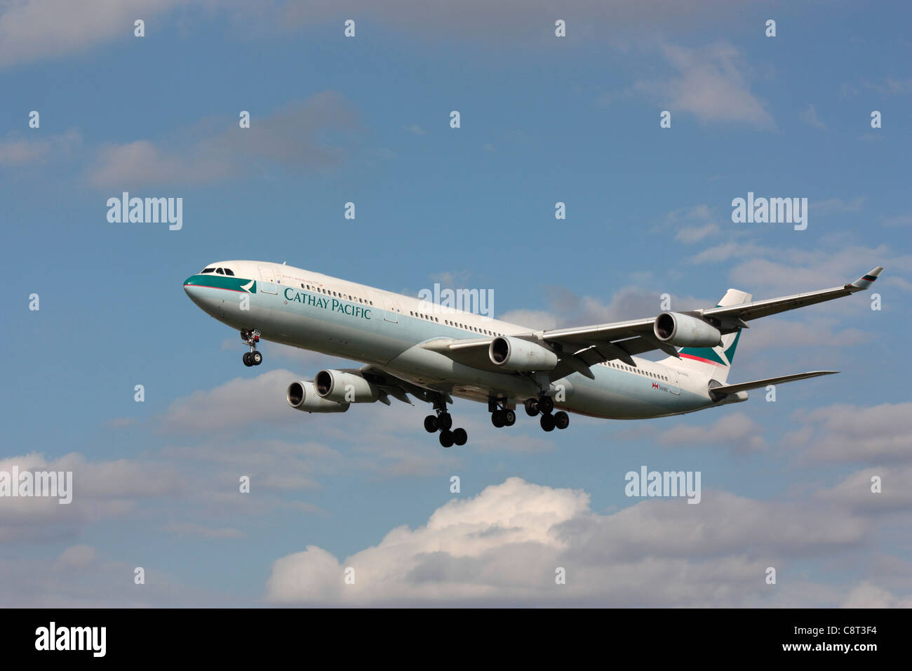 Cathay Pacific Airways Airbus A340-300 shortly before landing. Off-centre composition with copy space. Stock Photo