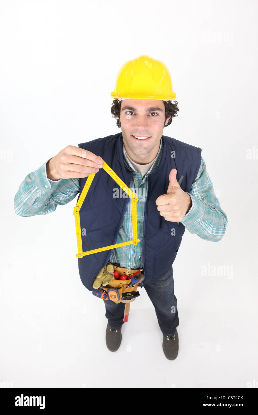 Construction worker with his folding ruler Stock Photo - Alamy