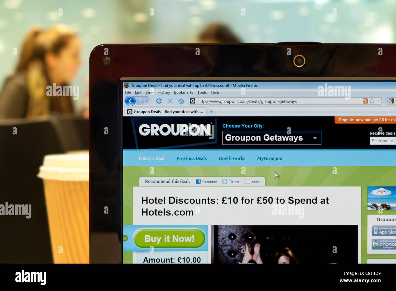 The Groupon website shot in a coffee shop environment (Editorial use only: print, TV, e-book and editorial website). Stock Photo