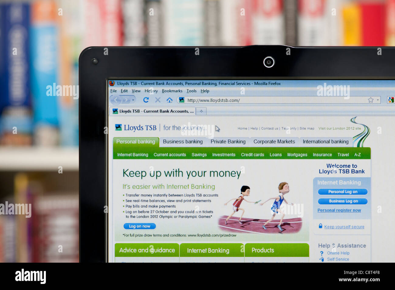 The Lloyds TSB website shot against a bookcase background (Editorial use only: print, TV, e-book and editorial website). Stock Photo