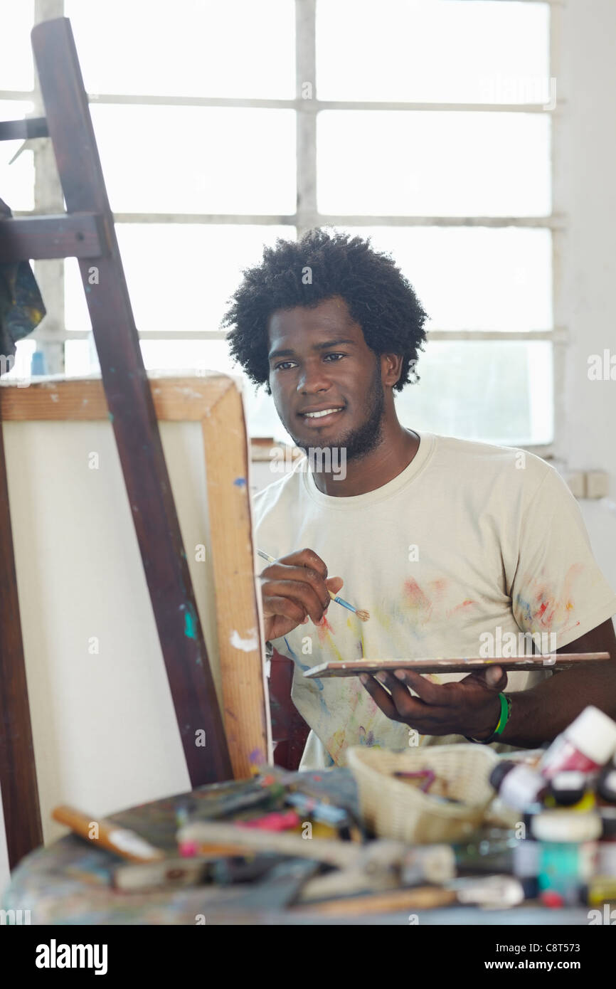 Black artist painting in art studio Stock Photo