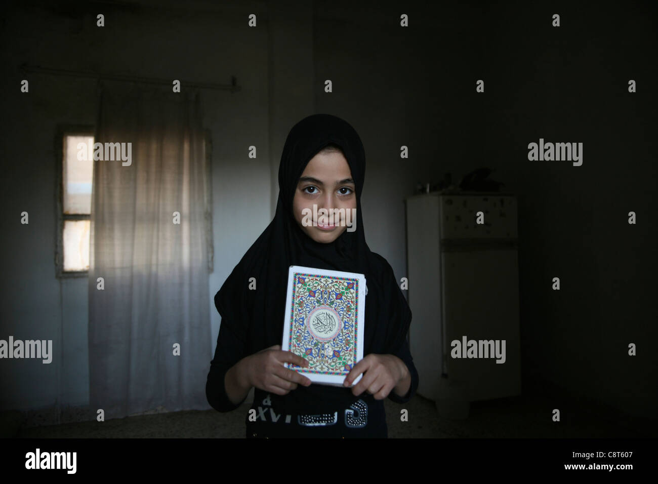 Refugee girl from Iraq in Amman, Jordan. Mosque on friday in Amman, Jordan Stock Photo