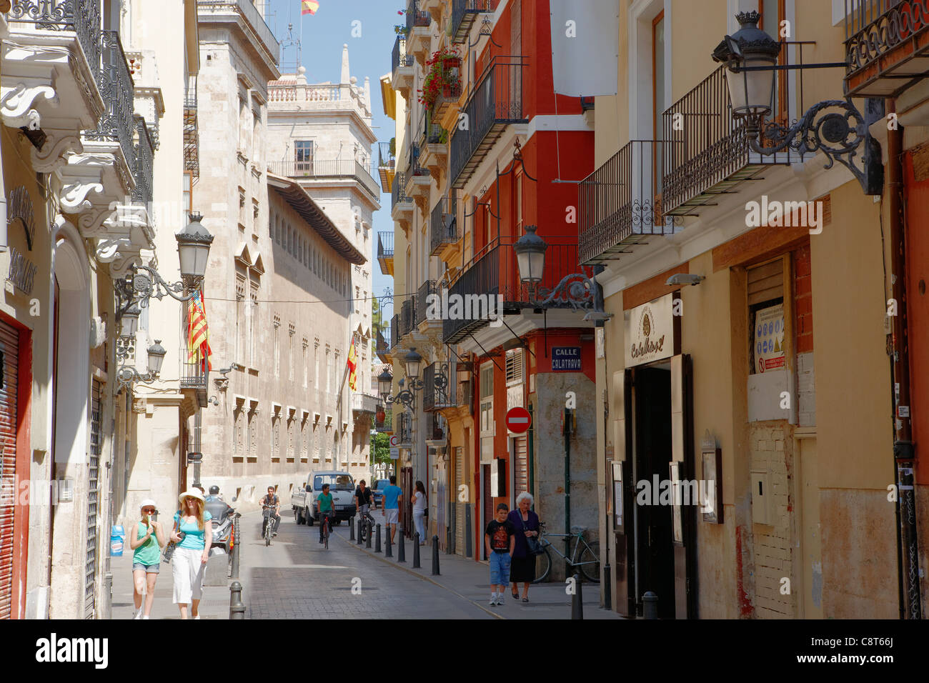 People walking along a narrow street in the old town of Valencia, Spain. Stock Photo
