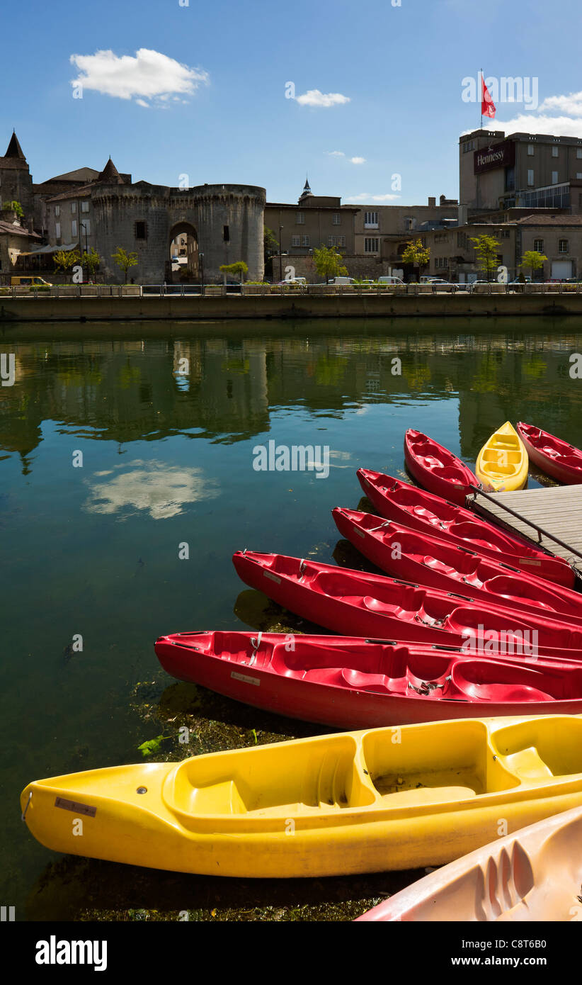 Kayaks on the Charente river, opposite the cognac house of Hennessy, Cognac, Charente, France Stock Photo