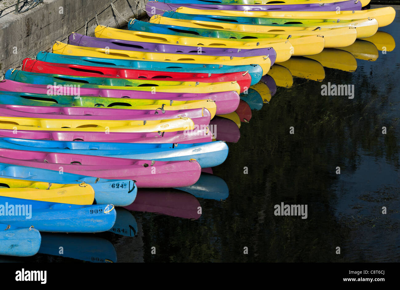Row of colorful canoes on the Charente river, Jarnac, Charente departement, France Stock Photo