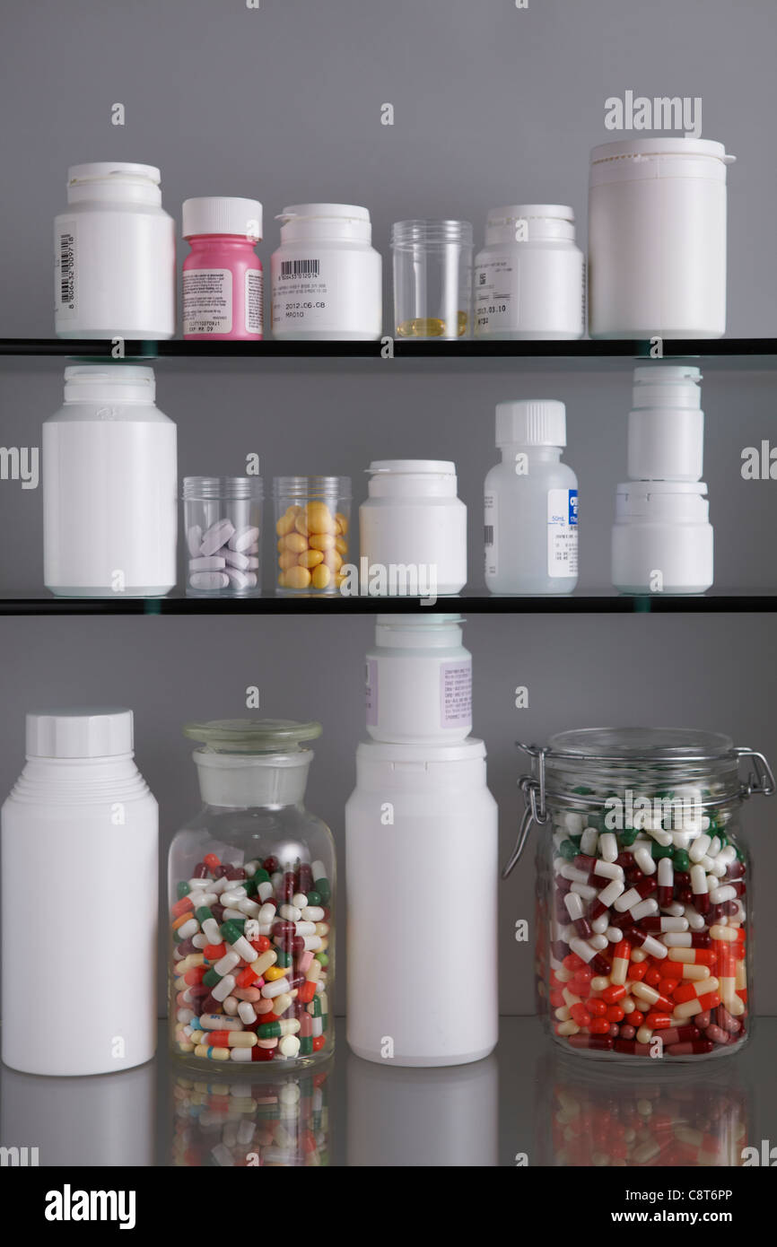 Close-up of pill bottles kept on shelves Stock Photo