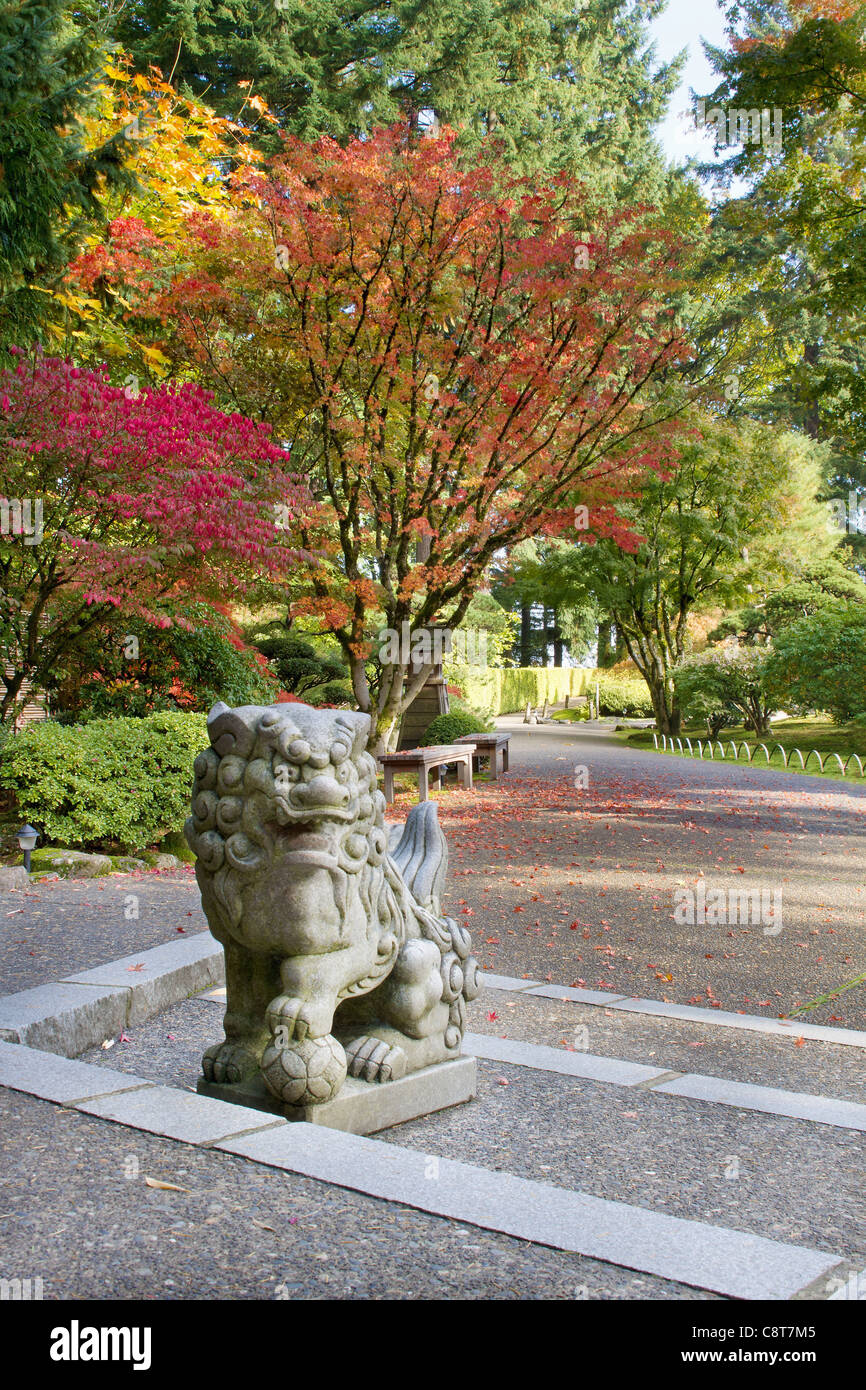 Shishi Lion Protector Stone Statue in Japanese Garden in Fall Stock Photo