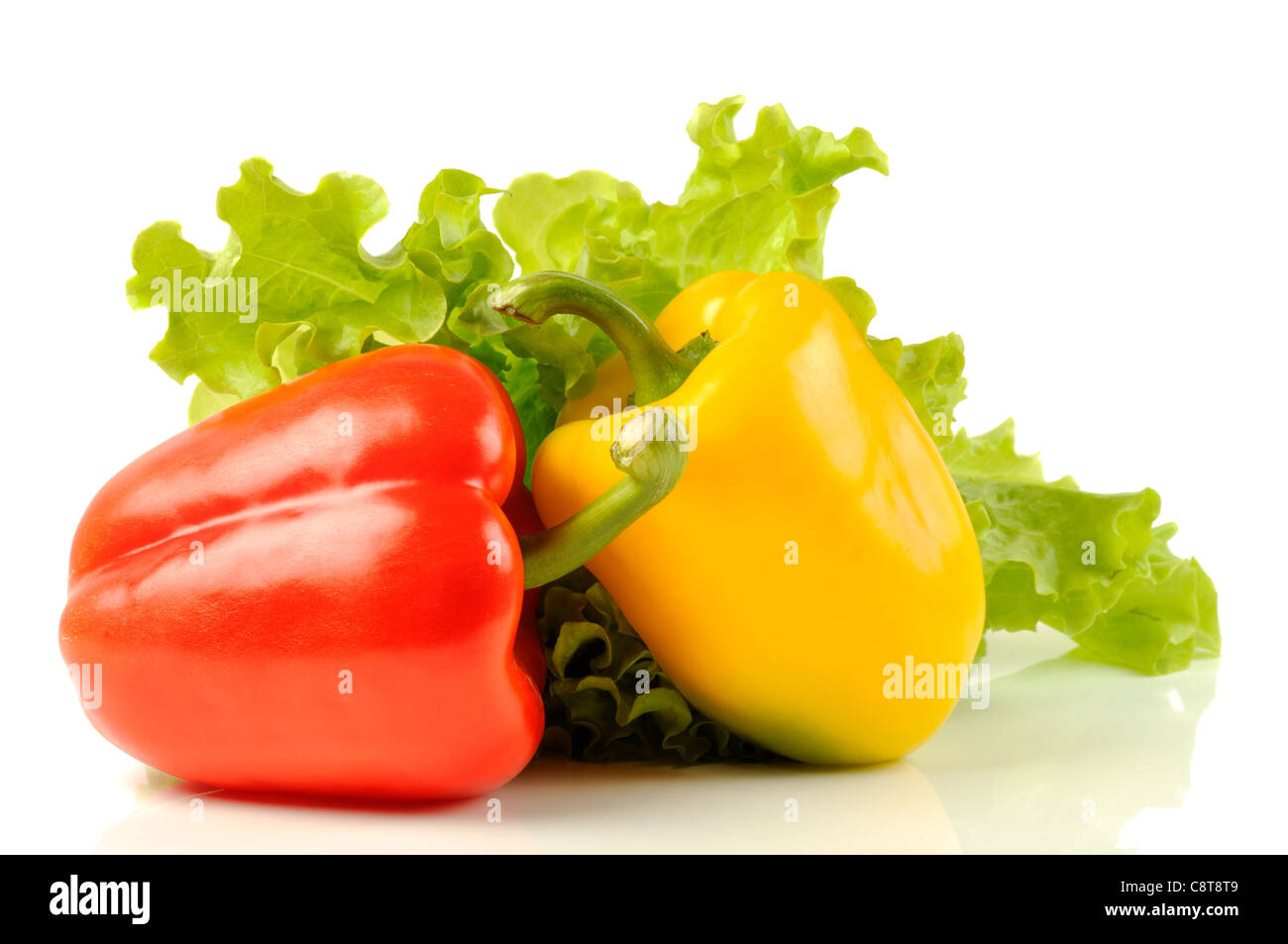 Red and yellow pepper with green salad, on a white background Stock ...