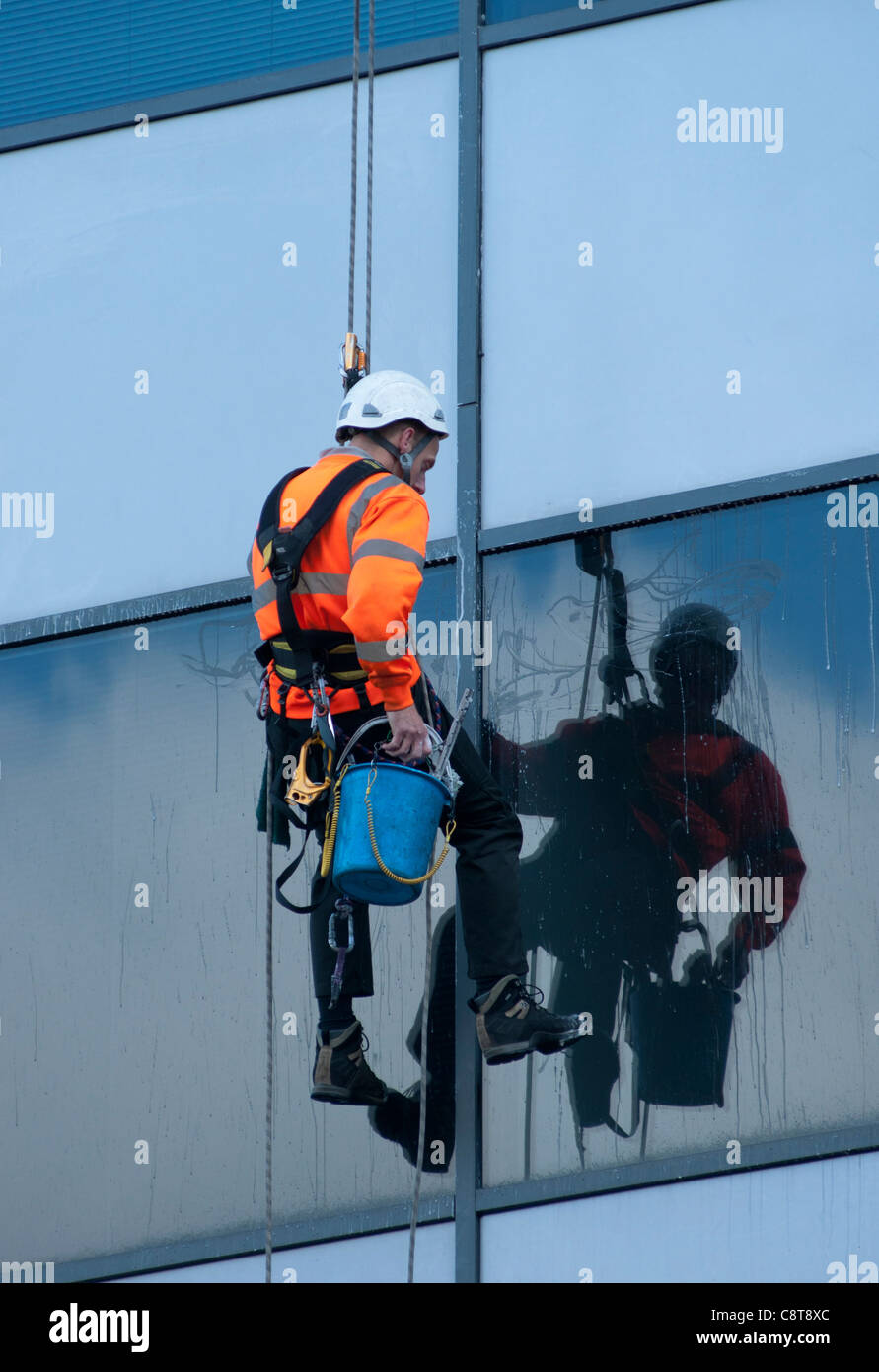 A window cleaner at work on an office building in Birmingham, UK. Stock Photo