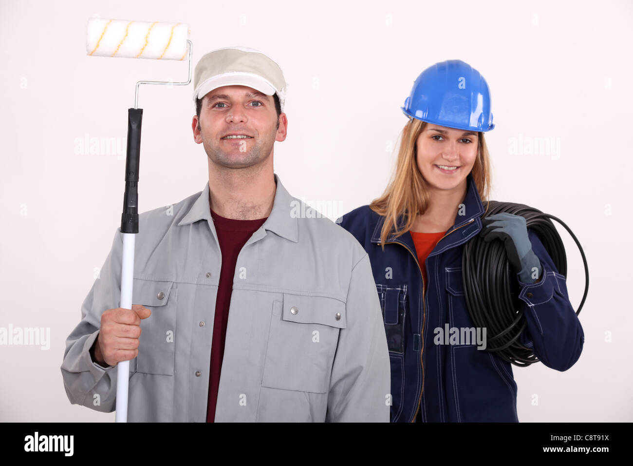 painter with roller and female electrician Stock Photo Alamy