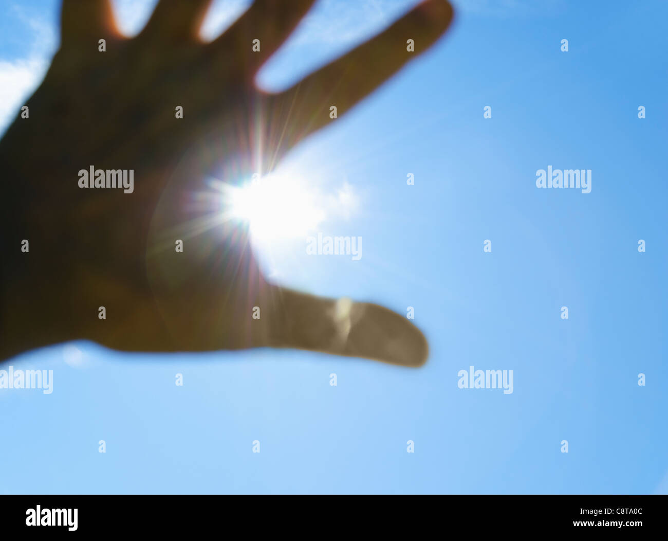 USA, New York City, Hand in front of sun Stock Photo
