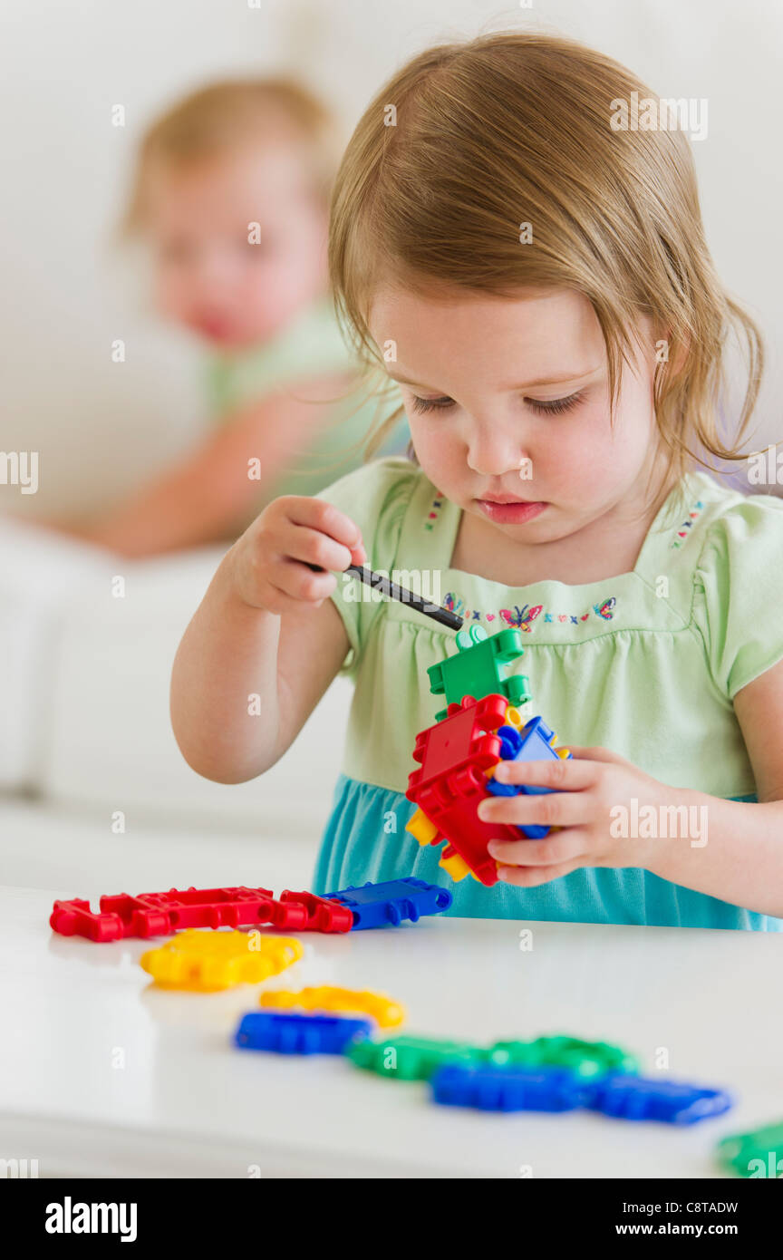 Girl playing with colorful toys Stock Photo - Alamy