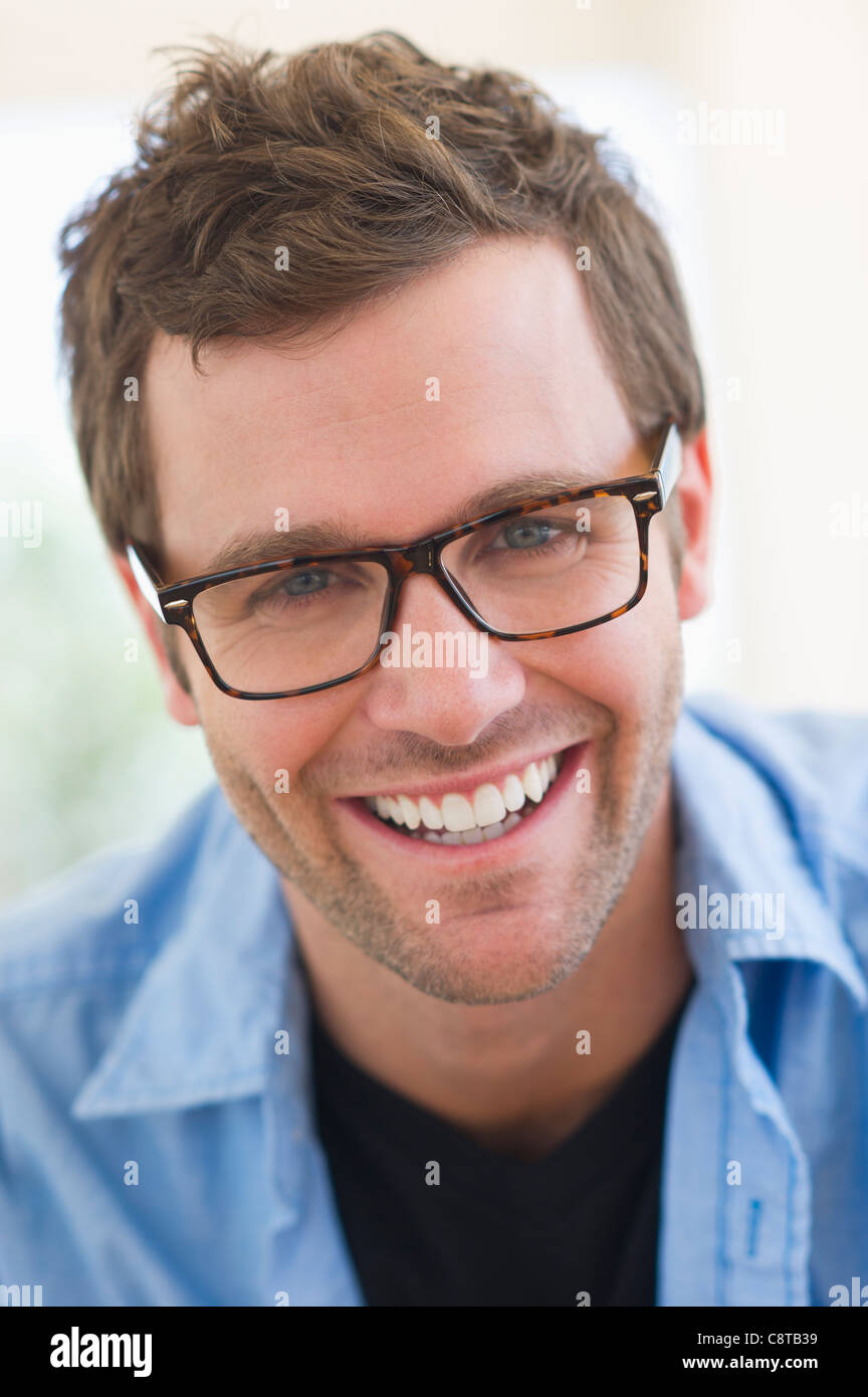 USA, New Jersey, Jersey City, Portrait of young man wearing glasses ...