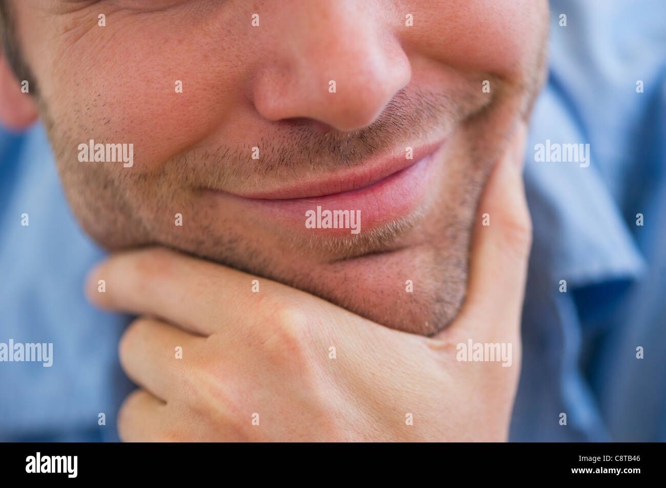 USA, New Jersey, Jersey City, Close-up of young man with hand on chin Stock Photo