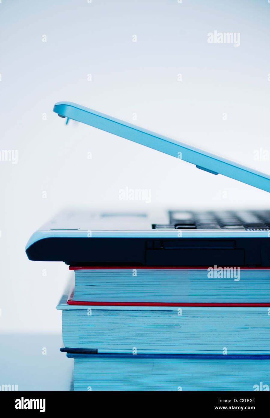Studio shot of books and laptop Stock Photo - Alamy