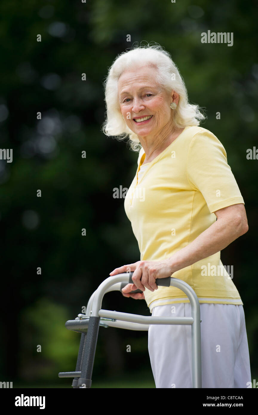 USA, New York State, Old Westbury, Senior woman walking with walker Stock Photo