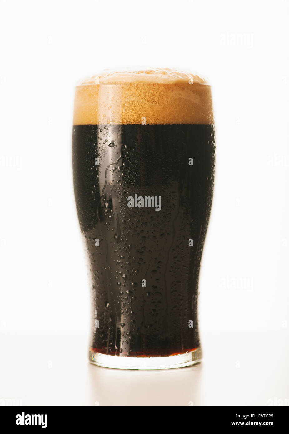 Studio shot of dark beer in glass Stock Photo