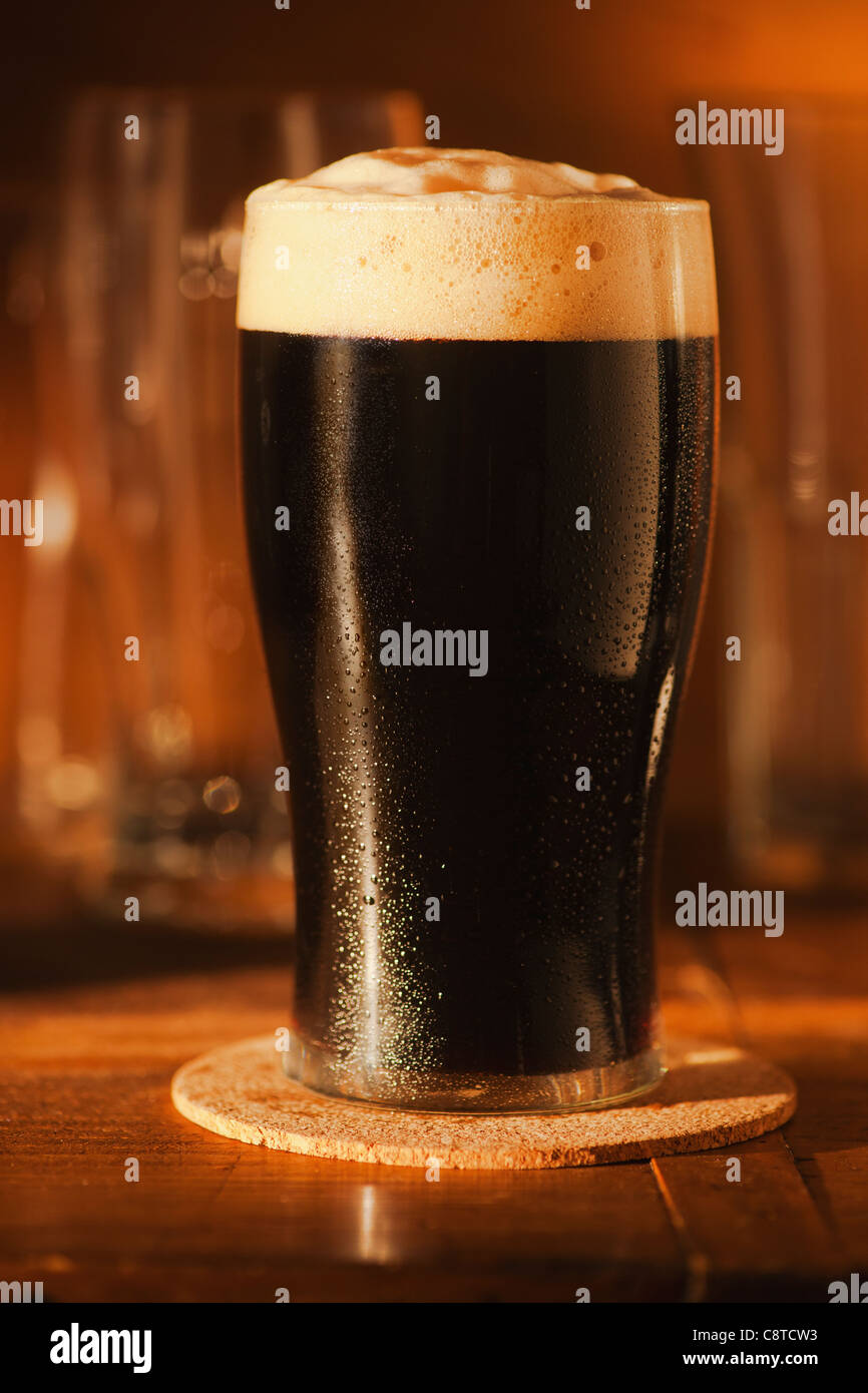 Ale in beer glass on bar counter Stock Photo