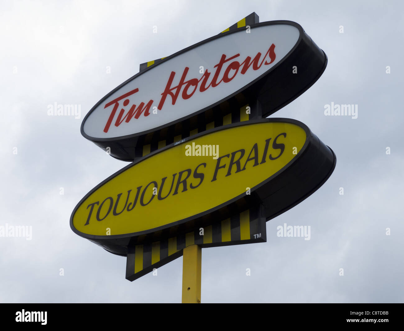 MONTREAL, CANADA - NOVEMBER 6, 2018: Tim Hortons Logo In Front Of One Of  Their Restaurants In Quebec With Their Slogan In French In The Background. Tim  Hortons Is A Cafe And