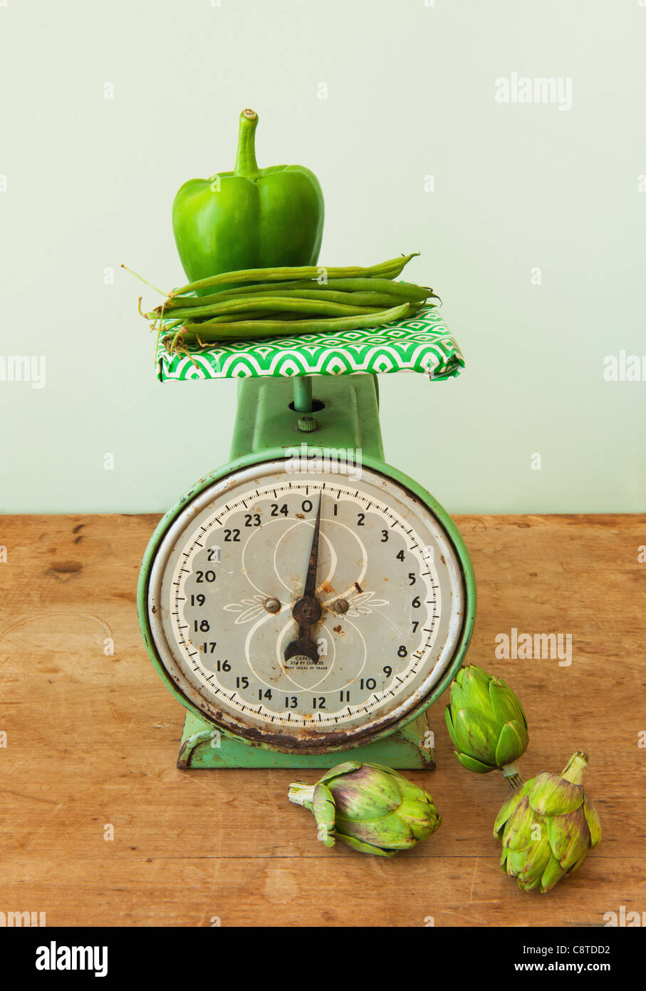 Vegetables on old-fashioned kitchen scale, studio shot Stock Photo