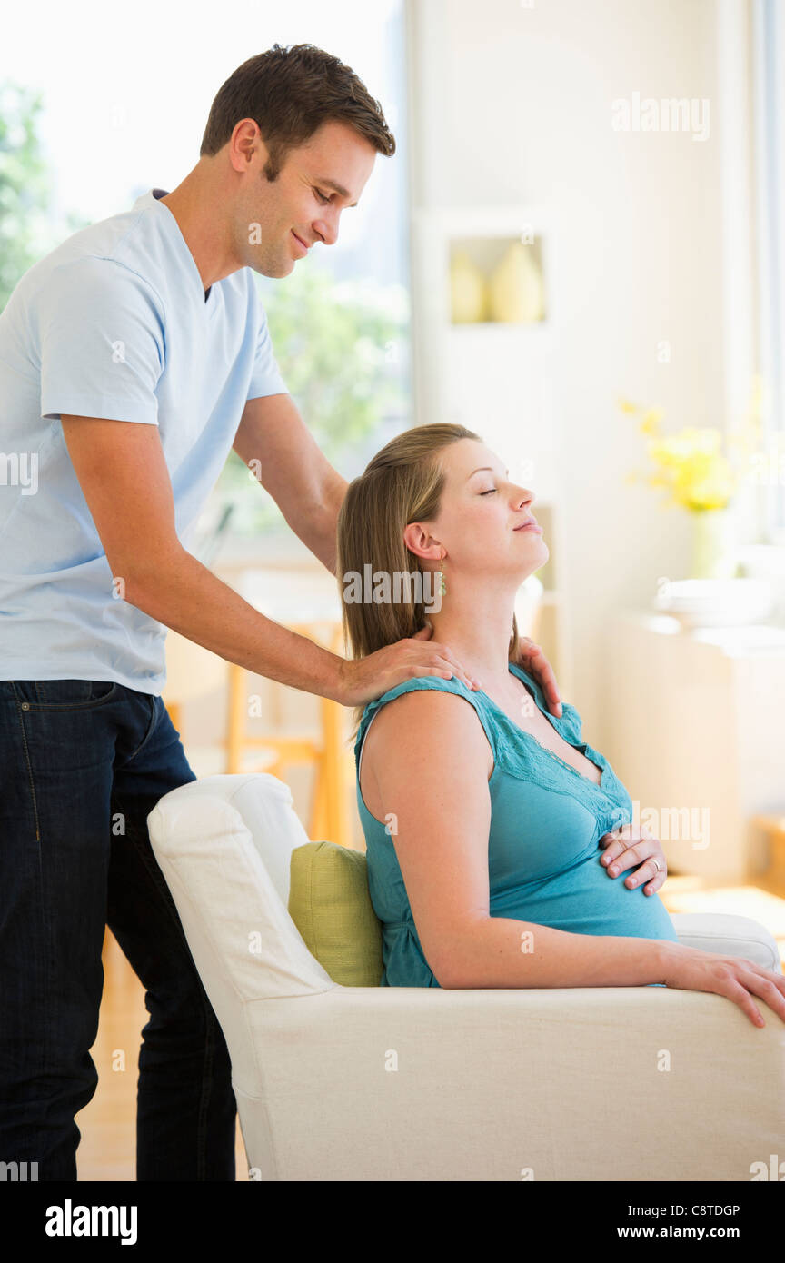 USA, New Jersey, Jersey City, Young man massaging pregnant partner Stock Photo