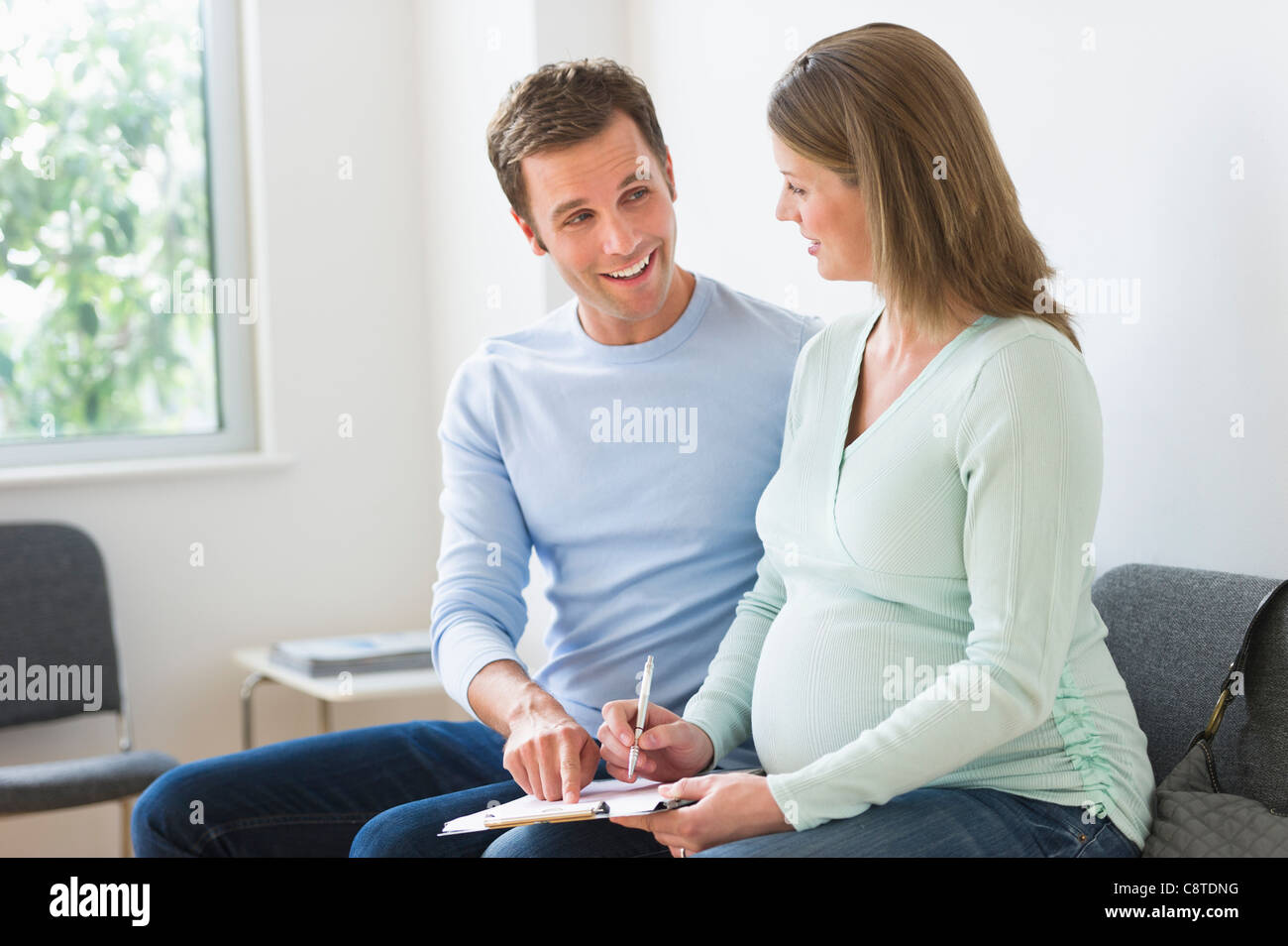 USA, New Jersey, Jersey City, Young couple in doctor's waiting room