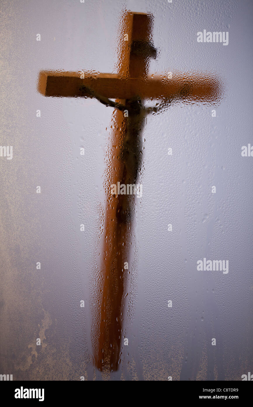 Blurred crucifix shot through glass Stock Photo