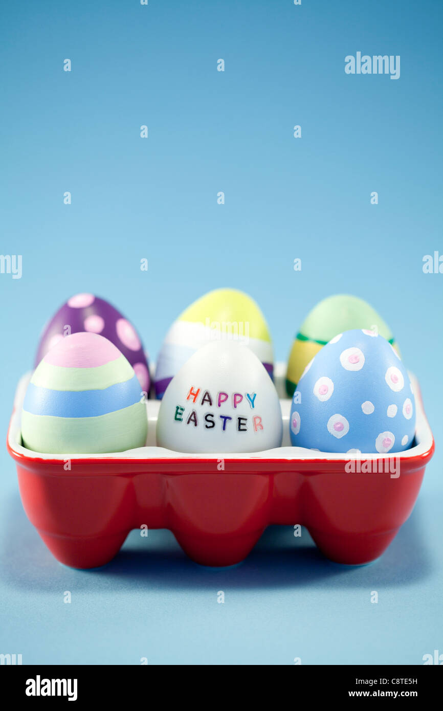 Colorful Easter eggs in egg carton Stock Photo