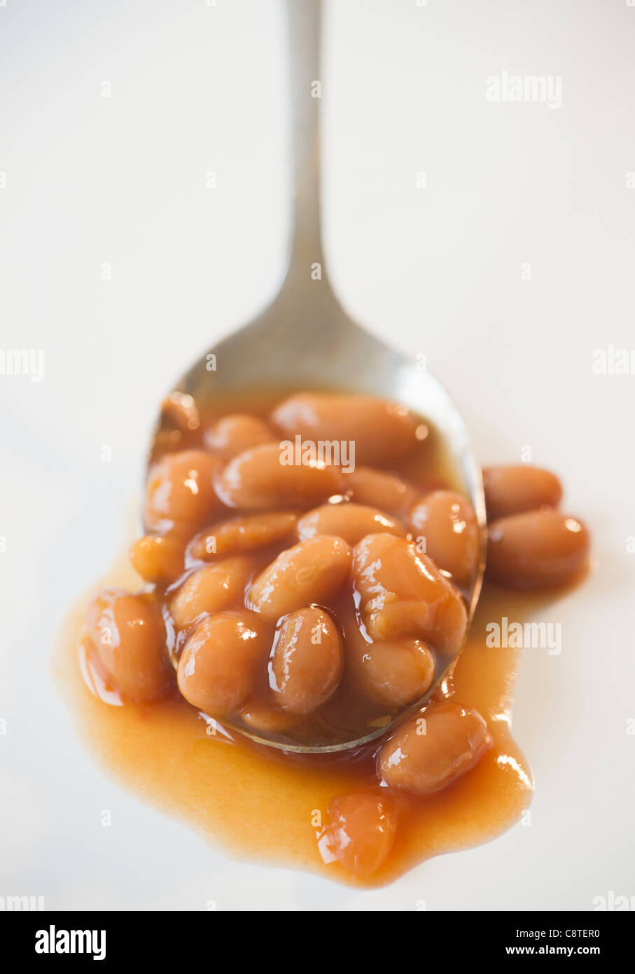 Close up of baked beans on spoon Stock Photo