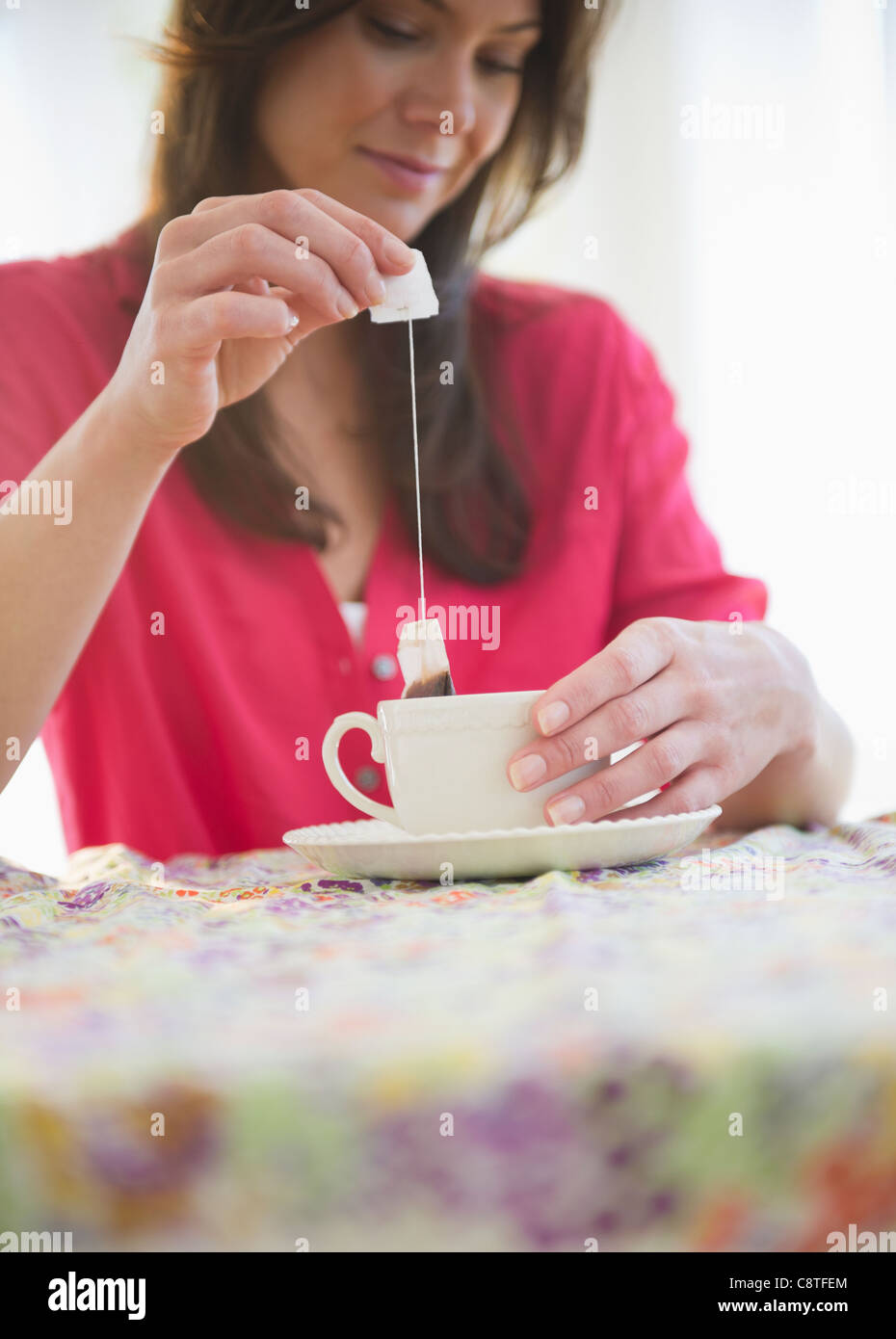 USA, New Jersey, Jersey City, Woman preparing tea Stock Photo