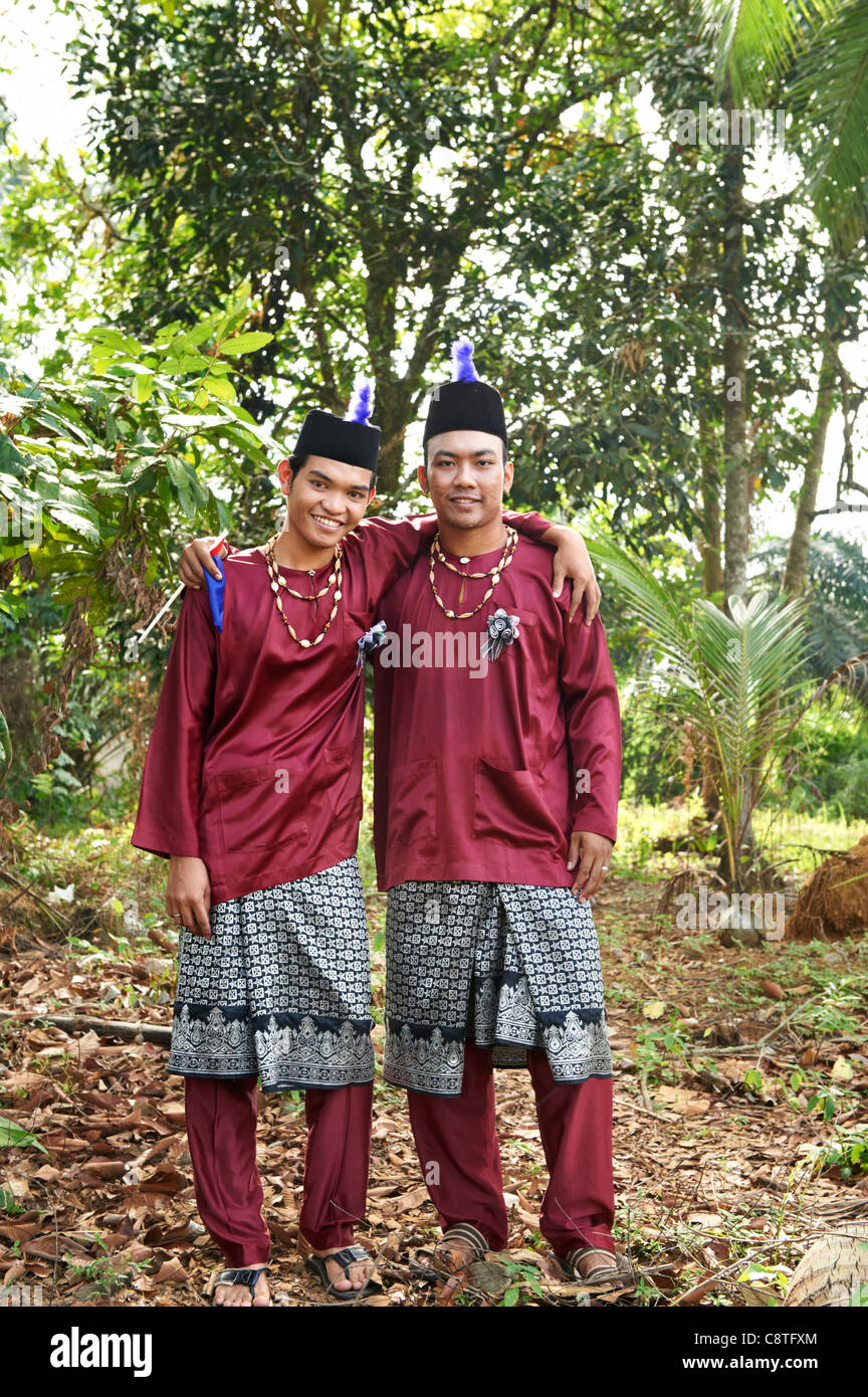 Two Malaysians men dressed up in their traditional wear Stock Photo Alamy
