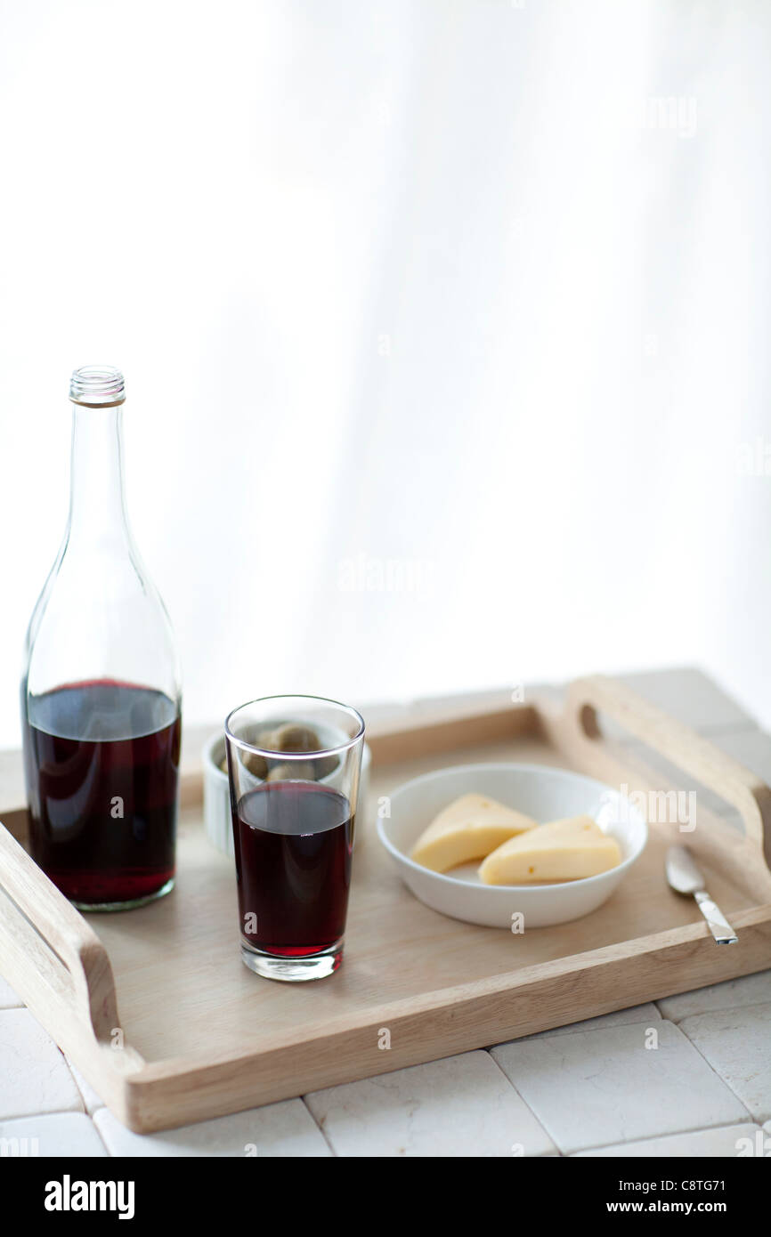 High angle view of red wine and cheese slice in wooden tray Stock Photo