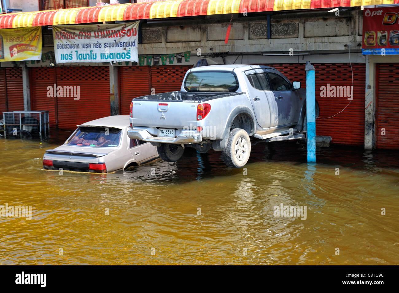 Pickup truck parked on car lift to prevent water damage from severe