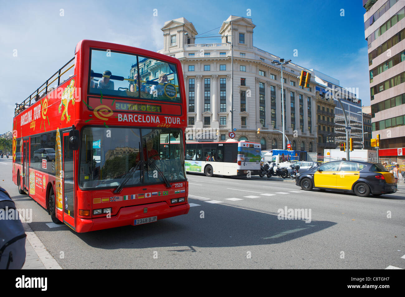 Red double-deck tour bus with open top on Passeig de Gracia. Barcelona, Catalonia, Spain. Stock Photo