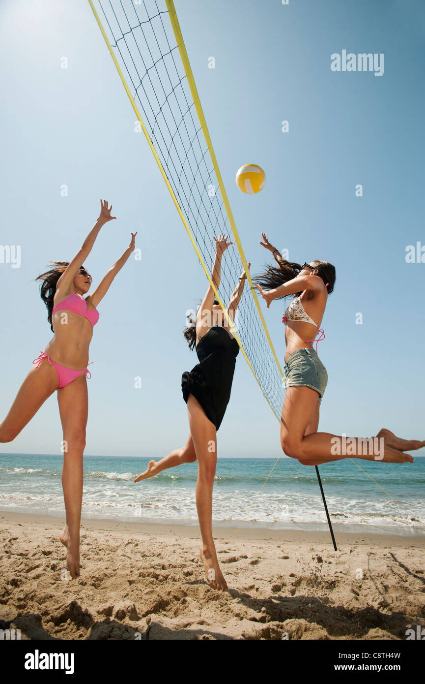 USA, California, Malibu, Three attractive young women playing beach volleyball Stock Photo