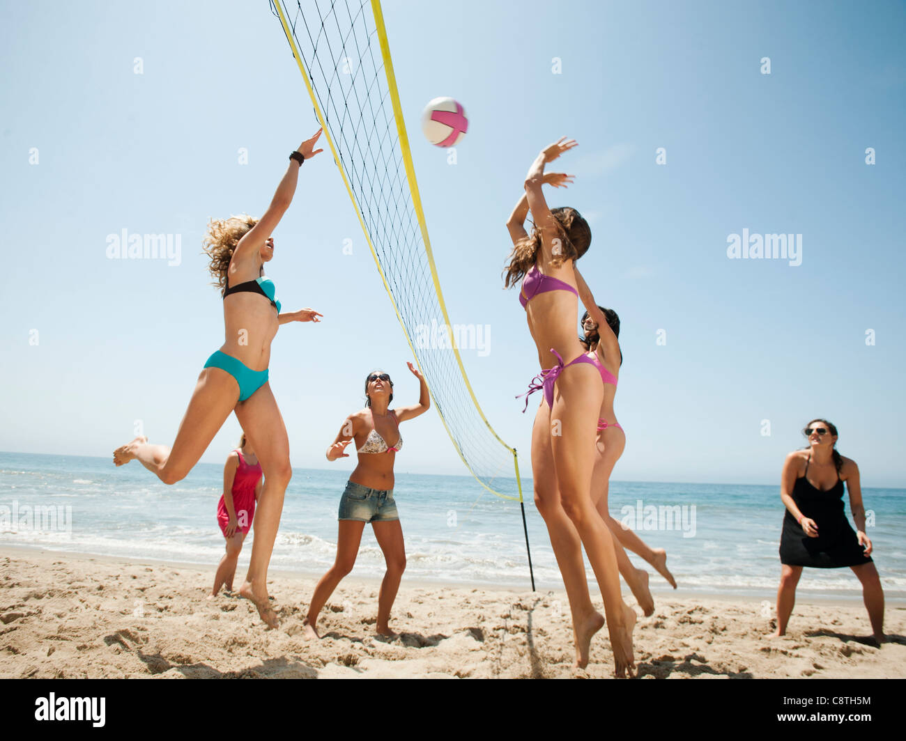 USA, California, Malibu, Group of young women playing beach volleyball Stock Photo